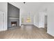 Spacious living room boasts fireplace with stone accent wall, hardwood floors, and natural light at 2964 Hollow Ln, Powder Springs, GA 30127