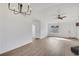 Open-concept living area features hardwood floors, natural light, and modern chandelier at 2964 Hollow Ln, Powder Springs, GA 30127