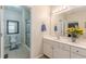 Bathroom featuring double sinks, a walk-in shower, and clean neutral decor at 4479 Caleb Xing, Powder Springs, GA 30127