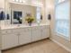 Bathroom features a double vanity with a large mirror and ample lighting at 4479 Caleb Xing, Powder Springs, GA 30127