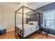 Bedroom featuring a canopy bed, a side table and an adjacent window at 4479 Caleb Xing, Powder Springs, GA 30127