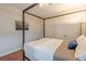 Bedroom with a canopy bed and light-colored walls with white trim and hardwood floors at 4479 Caleb Xing, Powder Springs, GA 30127