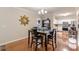 Dining area with wooden table, hardwood floors, and view into the kitchen at 4479 Caleb Xing, Powder Springs, GA 30127