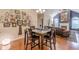 Spacious dining area with hardwood floors, Gathering tree art, and open layout at 4479 Caleb Xing, Powder Springs, GA 30127