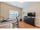 Home exercise room with treadmill, laptop on desk, and TV on dresser at 4479 Caleb Xing, Powder Springs, GA 30127