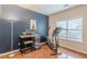 Bright exercise room featuring dark accent wall, hardwood floors and stationary bike at 4479 Caleb Xing, Powder Springs, GA 30127