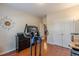 Exercise room features a treadmill, adjacent to a double door closet and a dark dresser with TV at 4479 Caleb Xing, Powder Springs, GA 30127