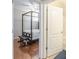 Hallway view showcasing an open bedroom with a canopy bed and an adjacent bathroom at 4479 Caleb Xing, Powder Springs, GA 30127