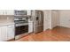 Well-lit kitchen features stainless steel appliances, a gas range, and classic white cabinets at 4479 Caleb Xing, Powder Springs, GA 30127