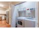 Convenient laundry room with modern washer and dryer next to kitchen, maximizing space and efficiency at 4479 Caleb Xing, Powder Springs, GA 30127