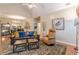 Comfortable living room featuring hardwood floors, vaulted ceiling, and a cozy seating area at 4479 Caleb Xing, Powder Springs, GA 30127