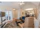 Open-concept living room with hardwood floors, a fireplace, and views of the kitchen at 4479 Caleb Xing, Powder Springs, GA 30127