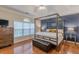 The main bedroom with a striking canopy bed, hardwood floors, and natural light at 4479 Caleb Xing, Powder Springs, GA 30127