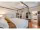 The main bedroom has hardwood floors, a canopy bed, and ensuite bathroom at 4479 Caleb Xing, Powder Springs, GA 30127