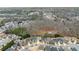 Aerial view of a residential area with houses nestled among trees, showcasing neighborhood layout at 3650 Bentbill Xing, Cumming, GA 30041