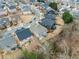 An aerial view showcasing a residential neighborhood with well-maintained homes and tree-lined streets at 3650 Bentbill Xing, Cumming, GA 30041