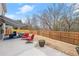 Backyard patio with outdoor seating and a wooden fence, creating a private and comfortable outdoor space at 3650 Bentbill Xing, Cumming, GA 30041