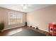 Bright bedroom with a window, exercise mat, weights and red side table at 3650 Bentbill Xing, Cumming, GA 30041