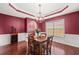 A dining room with wainscoting, decorative ceiling and adjacent butlers pantry with built in cabinets at 3650 Bentbill Xing, Cumming, GA 30041