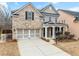 Exterior view of a brick and gray two-story home with a two car garage at 3650 Bentbill Xing, Cumming, GA 30041