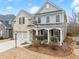 View of a charming two-story home featuring a brick facade, siding accents, and a covered front porch at 3650 Bentbill Xing, Cumming, GA 30041