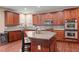 Kitchen with stainless steel appliances, mosaic backsplash, and wooden cabinets at 3650 Bentbill Xing, Cumming, GA 30041