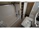 Bathroom featuring a white bathtub and shower, a sink with a marbled countertop and a storage closet at 4973 Horton Pl, Douglasville, GA 30135