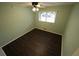 Bedroom with wood floors, a window, and light green walls at 4973 Horton Pl, Douglasville, GA 30135