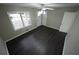 Well-lit bedroom featuring dark wood-look laminate flooring, a window, and a white door with brushed nickel hardware at 4973 Horton Pl, Douglasville, GA 30135