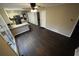 Open-concept living space featuring dark wood-look laminate flooring and views into the kitchen at 4973 Horton Pl, Douglasville, GA 30135