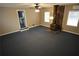 Cozy living room with plush carpeting and a decorative wood-burning stove against a stone accent wall at 4973 Horton Pl, Douglasville, GA 30135