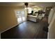 Open-concept living space featuring dark wood-look laminate flooring and sliding glass doors to outdoor deck at 4973 Horton Pl, Douglasville, GA 30135