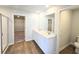Bathroom featuring double sinks, spacious shower, wood look flooring and a walk-in closet at 2359 Brown Dove Way (Lot 2), Grayson, GA 30017