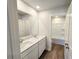 Bright bathroom featuring double sinks, a large mirror, and a shower/tub combo at 2359 Brown Dove Way (Lot 2), Grayson, GA 30017