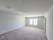 A large empty bedroom showcasing plush carpeting and a window at 2359 Brown Dove Way (Lot 2), Grayson, GA 30017