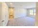Bright, carpeted bedroom with a window and views of the front yard at 2359 Brown Dove Way (Lot 2), Grayson, GA 30017