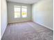 Bright bedroom with neutral carpet, a large window, and ample natural light at 2359 Brown Dove Way (Lot 2), Grayson, GA 30017