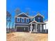 Charming two-story home with gray siding, white trim, and an attached two-car garage at 2359 Brown Dove Way (Lot 2), Grayson, GA 30017