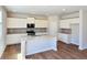 Stylish kitchen with white cabinets, granite countertops, stainless steel appliances, and a central island at 2359 Brown Dove Way (Lot 2), Grayson, GA 30017