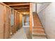 Unfinished basement with exposed beams, concrete floor, and staircase at 3113 Brians Creek Se Dr, Conyers, GA 30013