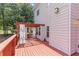 Large wooden deck features a pergola with curtains, ideal for outdoor living at 3113 Brians Creek Se Dr, Conyers, GA 30013