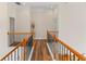 Upstairs hallway with dark wood floors, railing, and decorative vase on display at 3113 Brians Creek Se Dr, Conyers, GA 30013