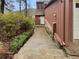 Exterior home view with stairs leading to the front door, stone accents, and natural landscaping at 80 Colony Ridge Dr, Alpharetta, GA 30022