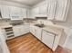 Functional kitchen with white cabinets, laminate countertops, and wood-look flooring at 80 Colony Ridge Dr, Alpharetta, GA 30022