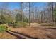 Private backyard and treed landscape create a peaceful outdoor oasis at 9865 Buice Rd, Alpharetta, GA 30022