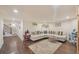 Spacious basement living area with sectional sofa, area rug, and hardwood floors at 9865 Buice Rd, Alpharetta, GA 30022