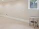 Unfinished basement with tile floor and a small window at 9865 Buice Rd, Alpharetta, GA 30022