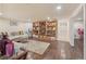 Basement living room with a large bookshelf and neutral decor at 9865 Buice Rd, Alpharetta, GA 30022