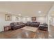 Finished basement area with leather sofas, rug, and hardwood floors at 9865 Buice Rd, Alpharetta, GA 30022