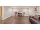 Large basement space featuring a TV, vases, and hardwood flooring at 9865 Buice Rd, Alpharetta, GA 30022